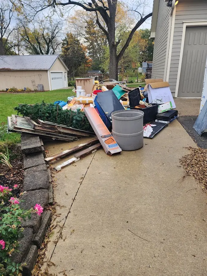 Dumpster being loaded with debris for Estate Cleanout Dumpster Rental in Church Point